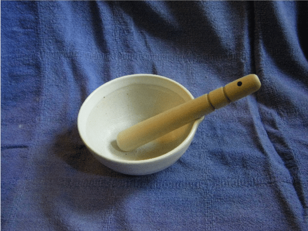 white grinding bowl mortar and pestle