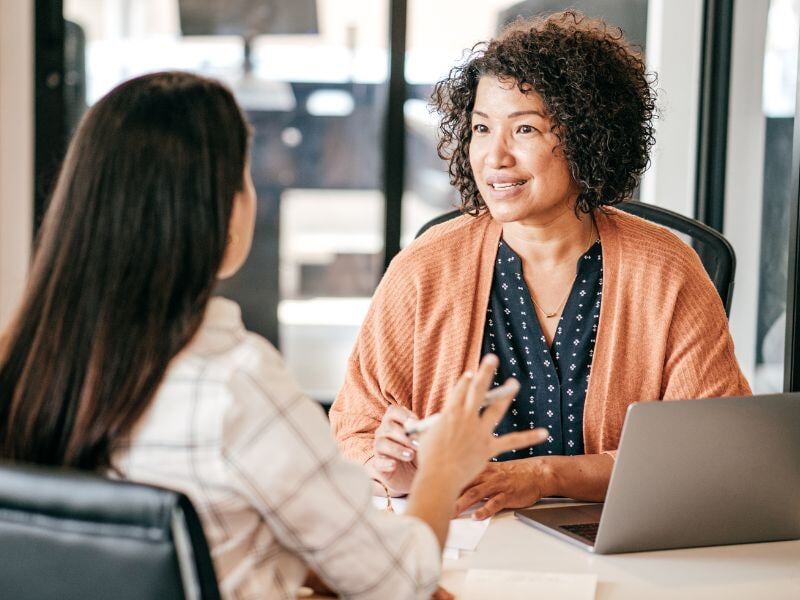 Two women sitting at a table in an interview