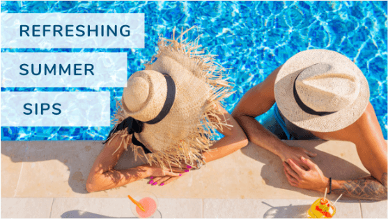 two people with large sun hats sitting in a pool with summer drinks next to them