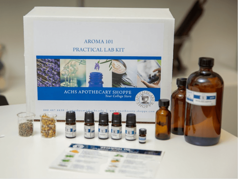 An ACHS Aroma 101 Practical Lab kit with essential oils, herbs, and oil bottles